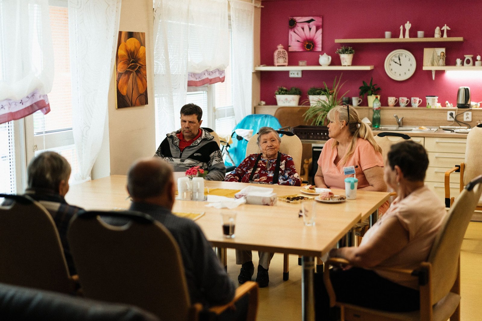 A diverse group of people smiling and interacting together, symbolizing community support and reconnecting with purpose at Restoration Recovery Residence